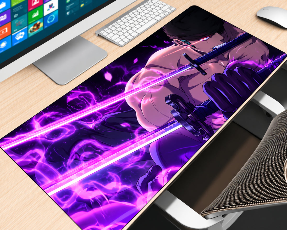 Roronoa Zoro One Piece extended gaming mouse pad featuring a close-up of the green-haired swordsman wielding swords surrounded by glowing purple and magenta energy, violet lightning effects, and a dark anime background, displayed on a light wood desk with a white keyboard, monitor, and mouse.