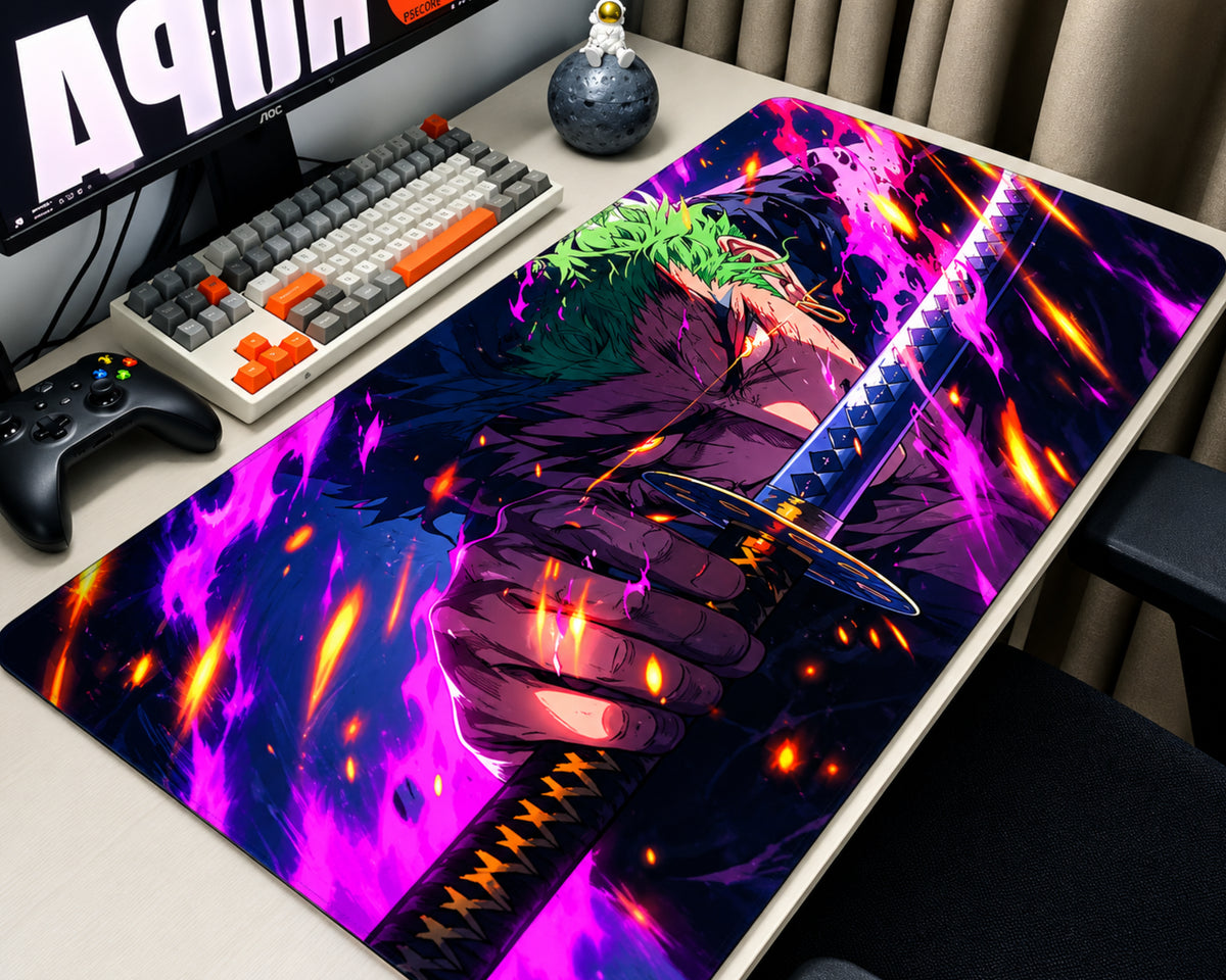 Extended anime gaming mouse pad featuring Roronoa Zoro with spiky green hair, gripping a detailed katana amid vibrant purple and magenta flames, glowing orange sparks, and a dark navy background, displayed on a white desk with a mechanical keyboard, black gaming controller, monitor, and astronaut figurine.