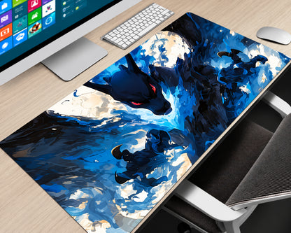 A large desk mat featuring a dynamic blue and black anime-style illustration of a dragon and warrior, shown on a light wood desk next to a computer monitor, keyboard, mouse, and office chair.