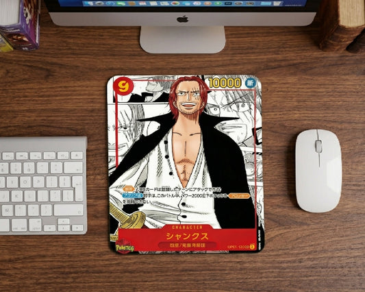 Red-Haired Shanks anime trading card style mouse pad on wooden desk with Apple iMac, white wireless keyboard, and minimalist One Piece inspired workspace