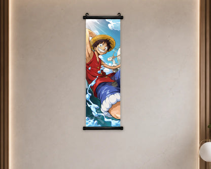 A vertical wall scroll poster featuring the anime character Monkey D. Luffy from One Piece, hanging on a beige textured wall with warm ambient lighting.