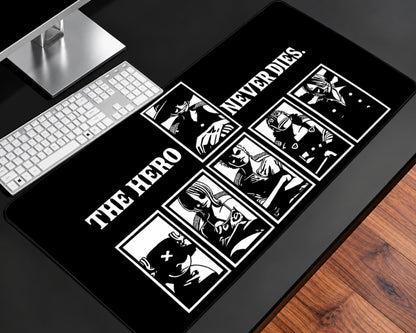 Black gaming mouse pad featuring white manga-style character panels, bold “The Hero Never Dies” typography, monochrome illustrations, and a minimalist high-contrast design.