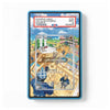 A PSA graded protective case for a trading card, featuring a blue border and a clear top label showing a PSA slab example header. The case contains an illustrated card depicting a bustling market scene with characters and wooden structures.