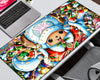 A large rectangular desk mat featuring a colorful Christmas-themed One Piece illustration, shown on a white desk next to a laptop and chair.
