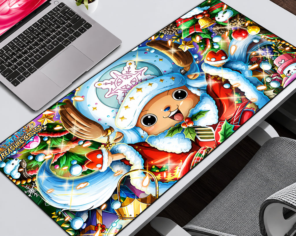 A large rectangular desk mat featuring a colorful Christmas-themed One Piece illustration, shown on a white desk next to a laptop and chair.