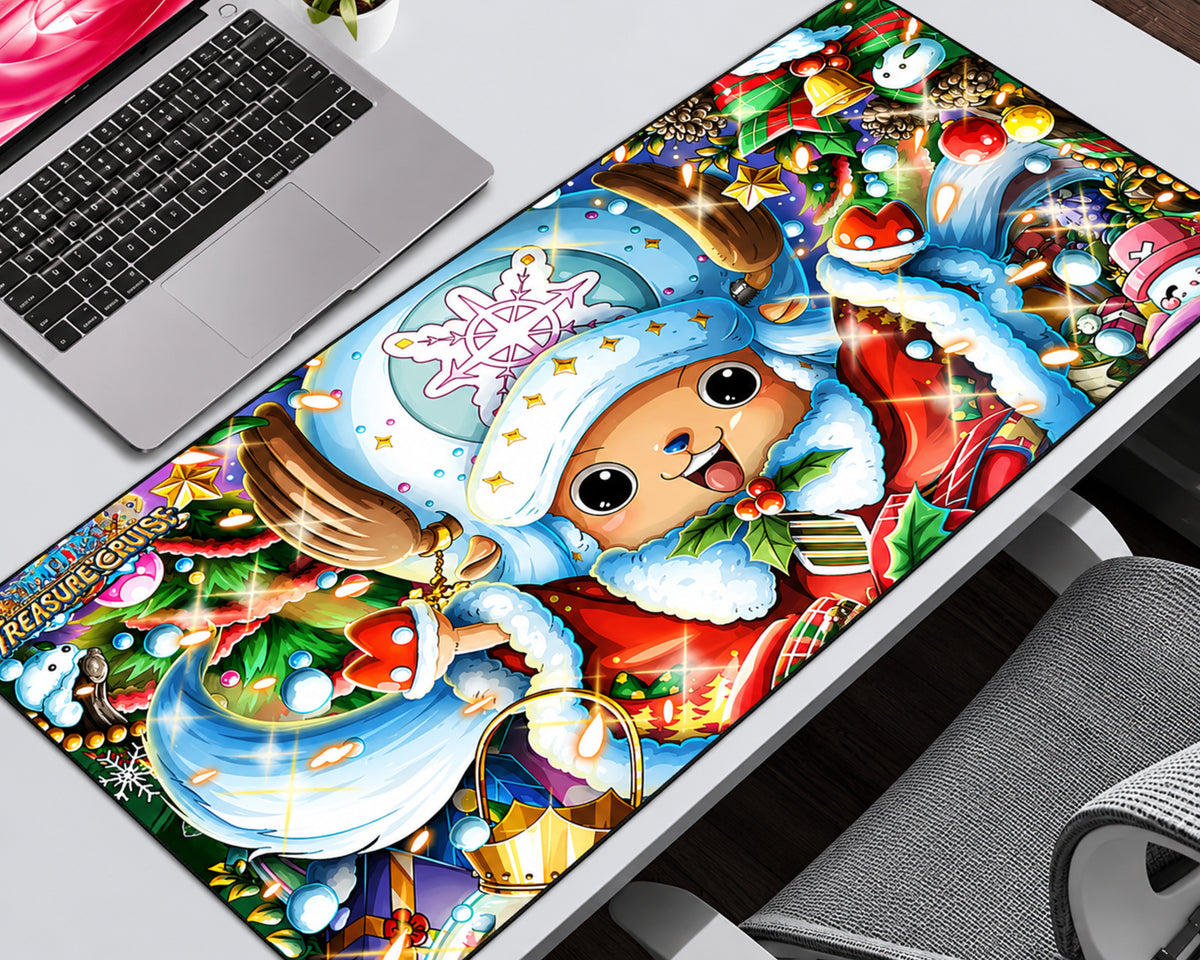 A large rectangular desk mat featuring a colorful Christmas-themed One Piece illustration, shown on a white desk next to a laptop and chair.