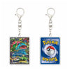 Two Pokémon-themed keychains shown side by side on a plain white background. The left keychain features a colorful Pokémon card with a metal clasp, and the right keychain shows a blue Pokémon card with a Pokémon Ball graphic and the Pokémon logo.