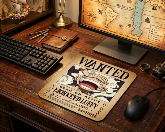 Vintage One Piece Monkey D. Luffy wanted poster anime mouse pad on rustic wooden gaming desk with mechanical keyboard, pirate map monitor wallpaper, and nautical decor aesthetic