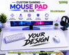 A large white gaming mouse pad displayed on a desk setup, with a keyboard, mouse, monitor, headphones, plants, and promotional text including 'CUSTOM GAMING MOUSE PAD', 'XXL SIZE', '12 x 24 inches', and 'YOUR DESIGN'.