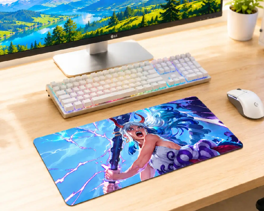 A large rectangular gaming desk mat featuring a colorful anime-style illustration of a female warrior with blue hair and lightning effects, placed on a light wood desk next to a keyboard, mouse, and computer monitor.