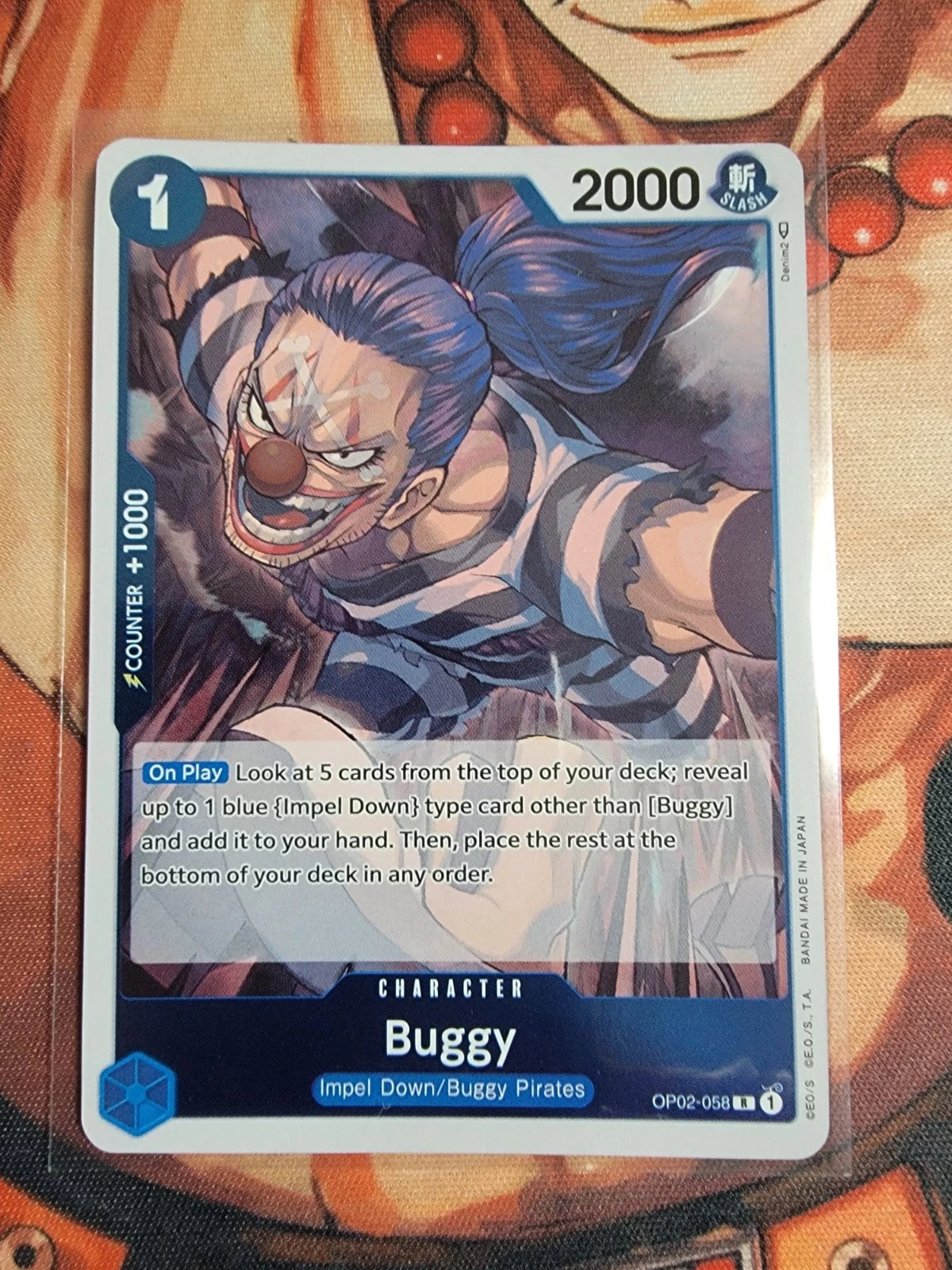 One Piece TCG Buggy OP02-058 rare foil card from Paramount War set featuring 2000 power and Impel Down search ability.