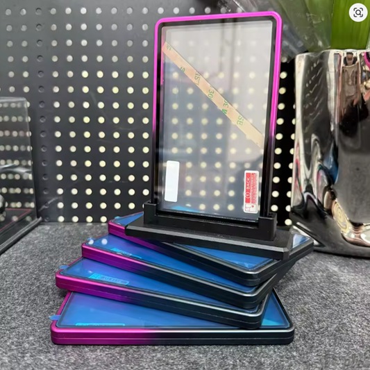 Stack of blue and pink electronic devices on a gray surface with a pegboard background