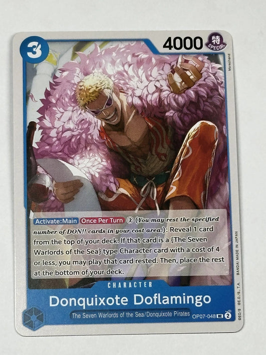 One Piece TCG character card OP07-048 featuring Donquixote Doflamingo with his signature pink feather coat and tinted glasses, pointing forward with a calculating grin.