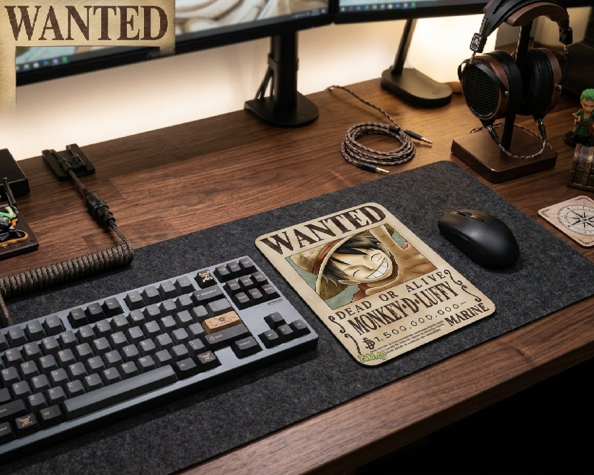 Monkey D. Luffy wanted poster anime mouse pad on dark felt desk mat with mechanical keyboard, gaming mouse, dual monitor setup, and premium wooden gaming workspace