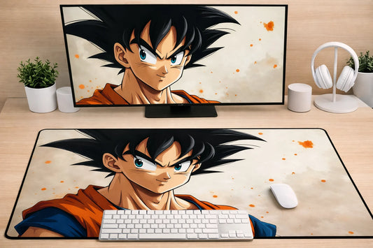 Large 24x12 inch Dragon Ball mousepad featuring a portrait of Goku with an artistic orange splatter background on a clean desk setup.
