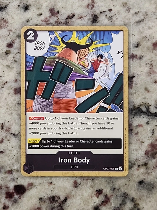 One Piece TCG event card OP07-095 titled Iron Body featuring a muscular figure with yellow hair in a defensive stance while Luffy runs in the background.