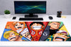 Large 24x12 inch One Piece mousepad featuring the faces of Luffy, Zoro, Nami, Sanji, and Usopp on a clean gaming desk setup.
