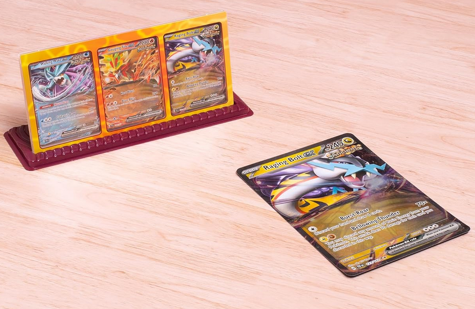 Trading cards on a wooden surface with a card holder.