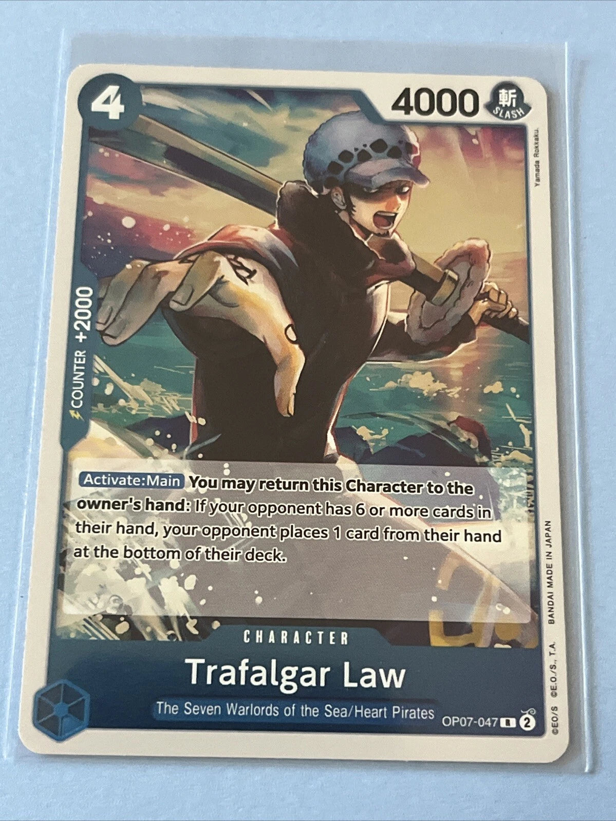 One Piece TCG character card OP07-047 featuring Trafalgar Law in a winter coat and hat reaching forward with his hand, with a submarine and ocean waves in the background.